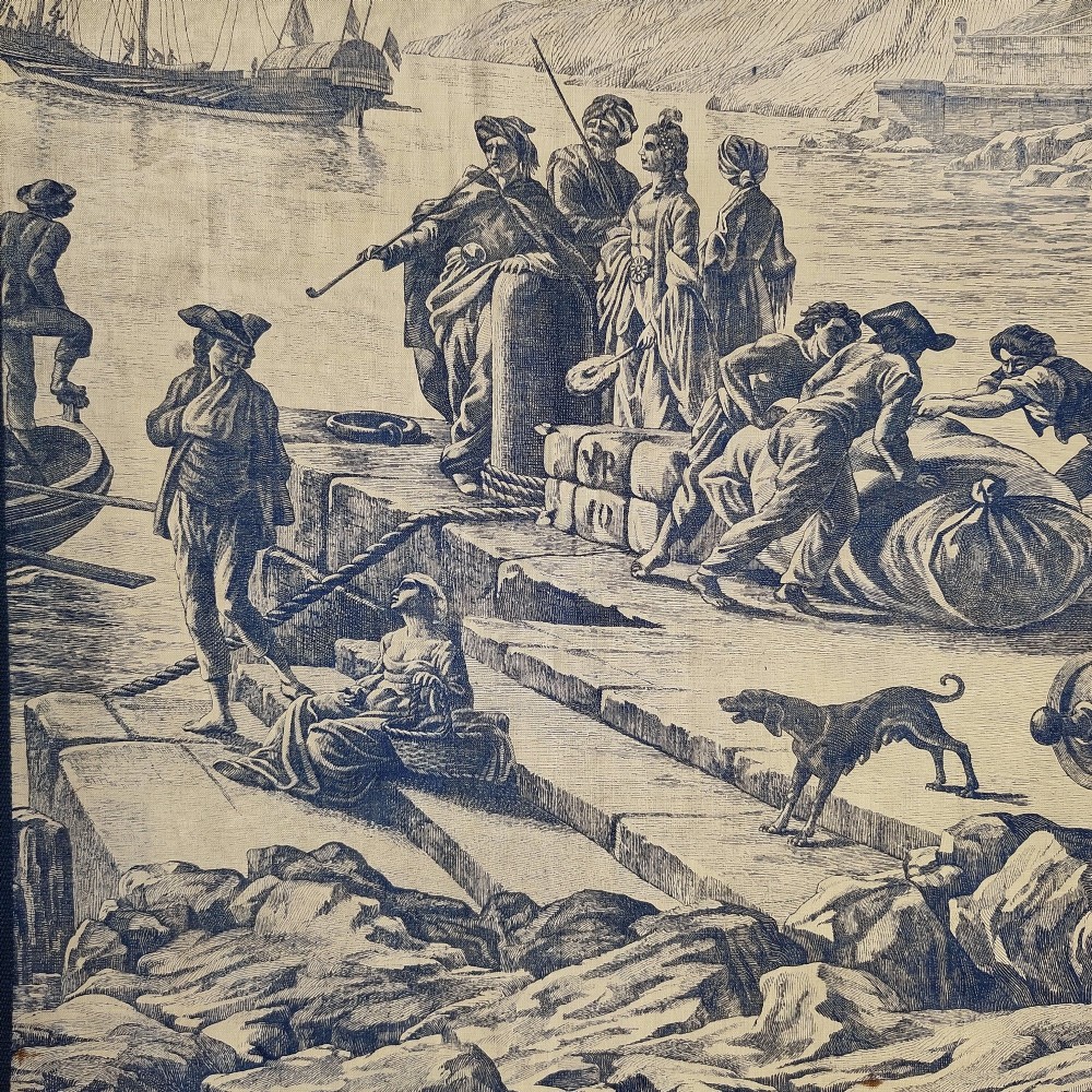 A rectangular late 19th-century toile textile panel featuring blue copperplate-printed maritime scenes on a cream cotton ground, bordered by dark navy fabric. View IV