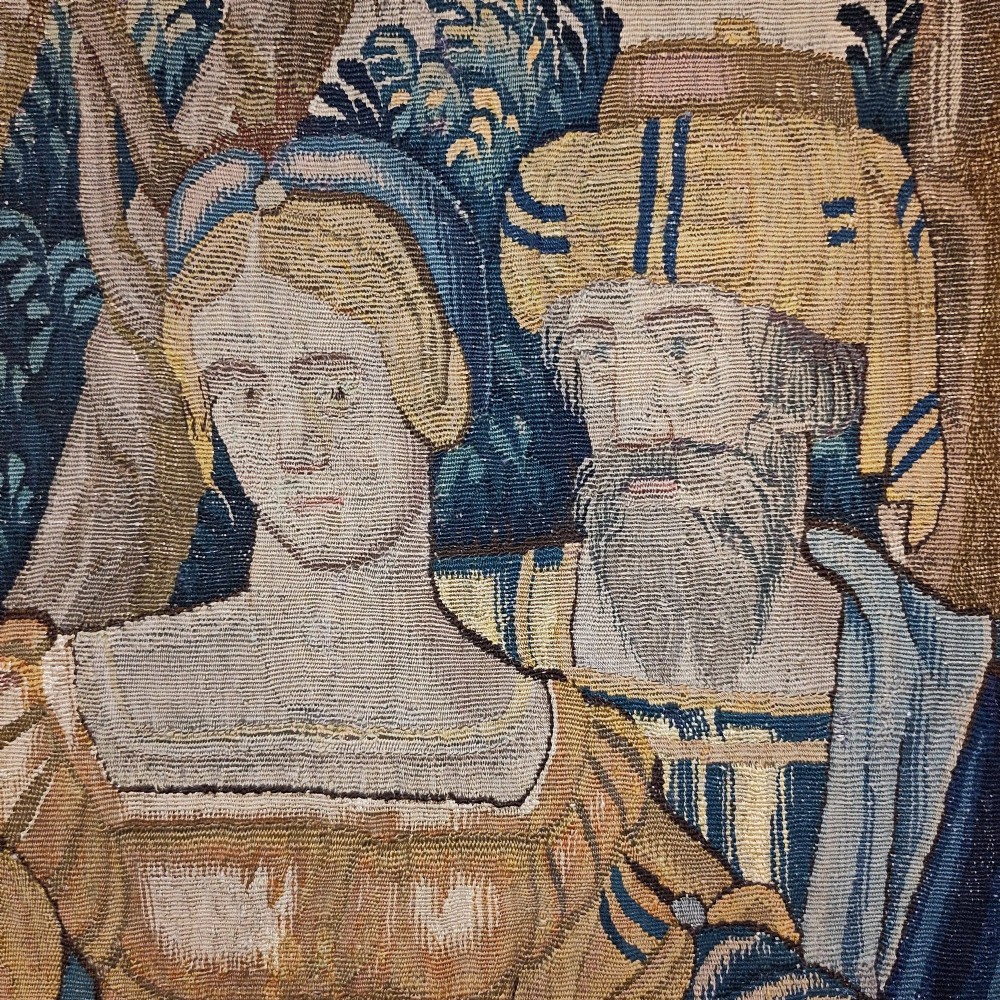 A tall rectangular Flemish tapestry panel depicting a woman and man in Renaissance attire standing in a wooded landscape. View IV