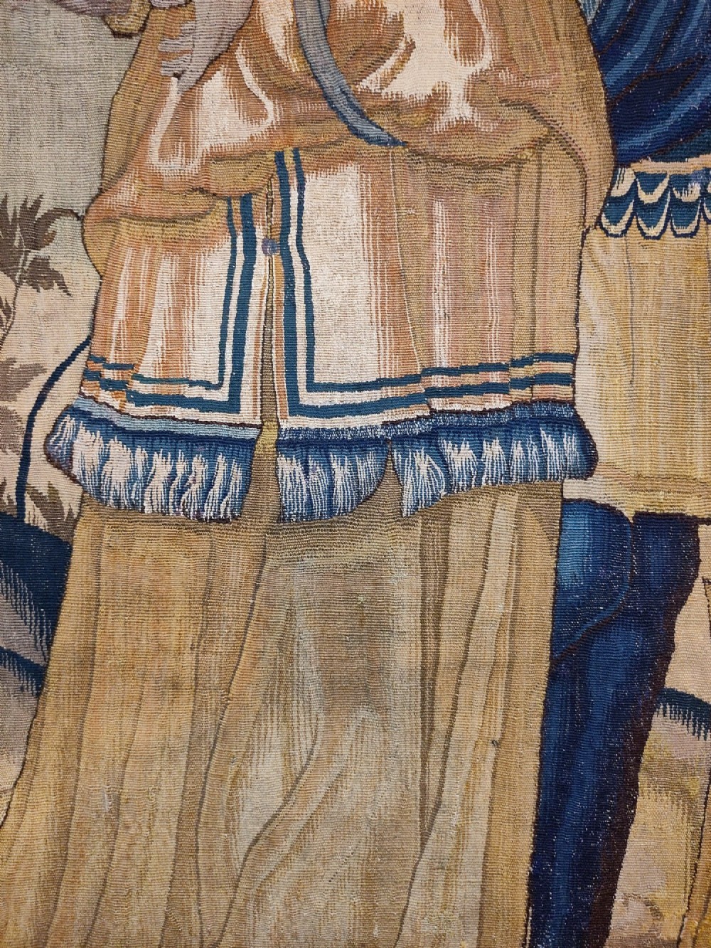 A tall rectangular Flemish tapestry panel depicting a woman and man in Renaissance attire standing in a wooded landscape. View VIII