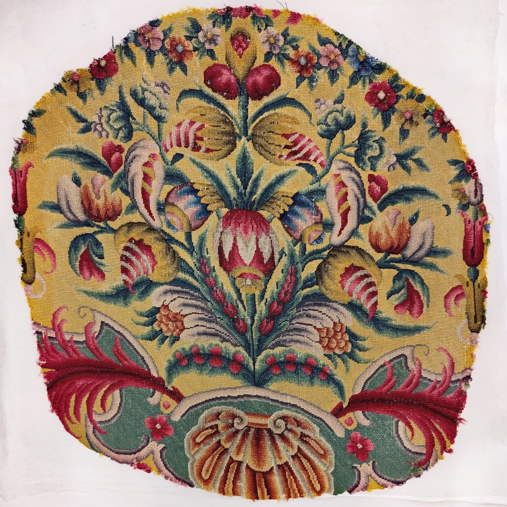 Two eighteenth-century yellow wool and silk needlework textile panels decorated with botanical motifs and acanthus leaf scrollwork for a chair seat and back. View II