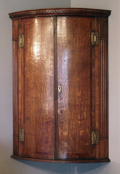George III oak bow front corner cupboard