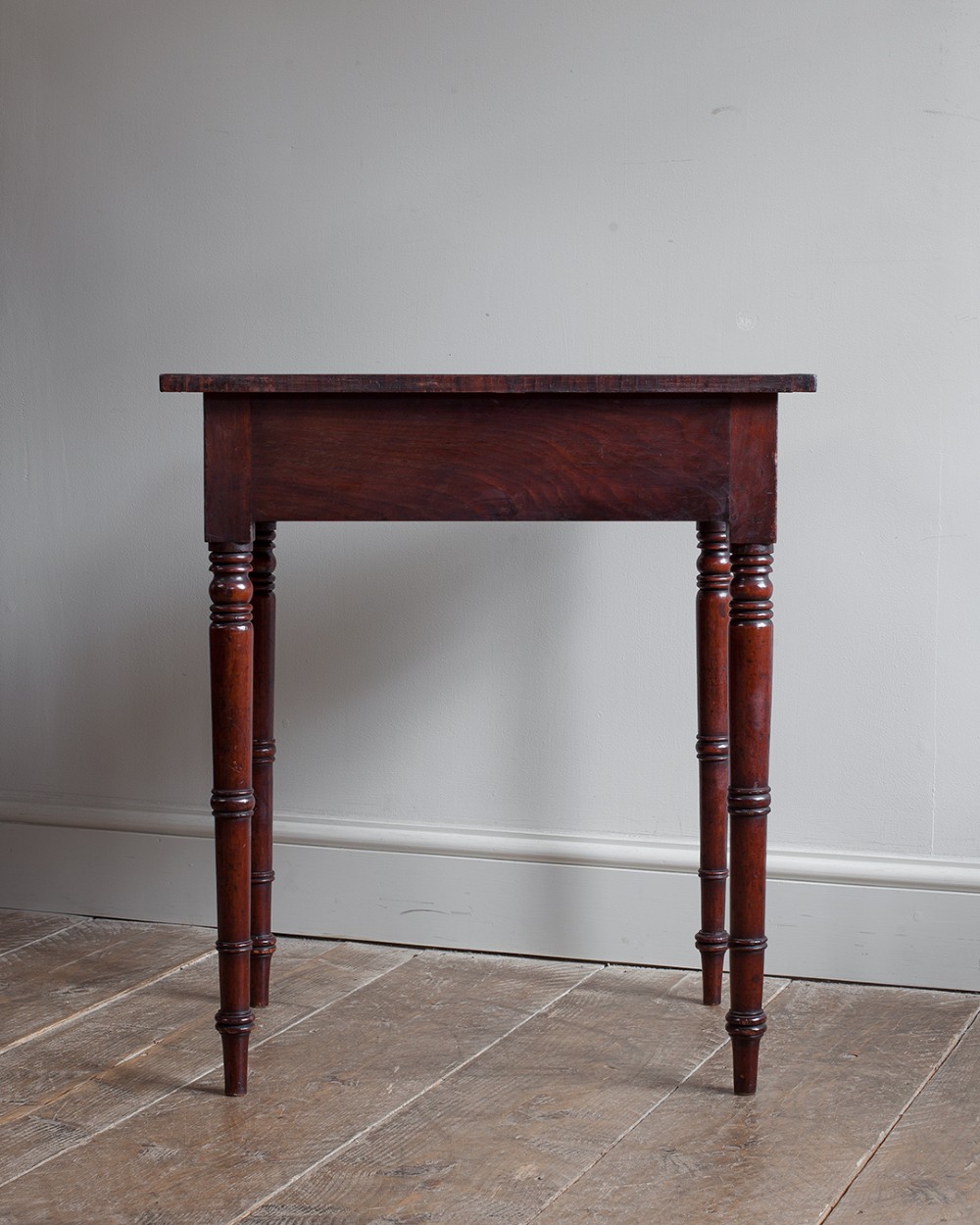 A small George IV mahogany side table featuring a single drawer with wooden knobs and slender turned legs. View II