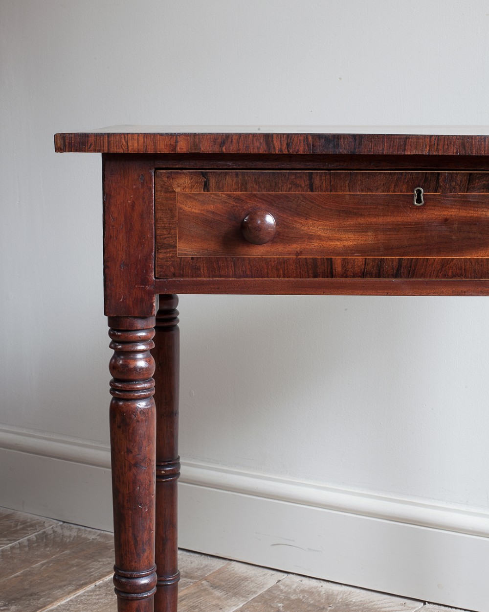 A small George IV mahogany side table featuring a single drawer with wooden knobs and slender turned legs. View III