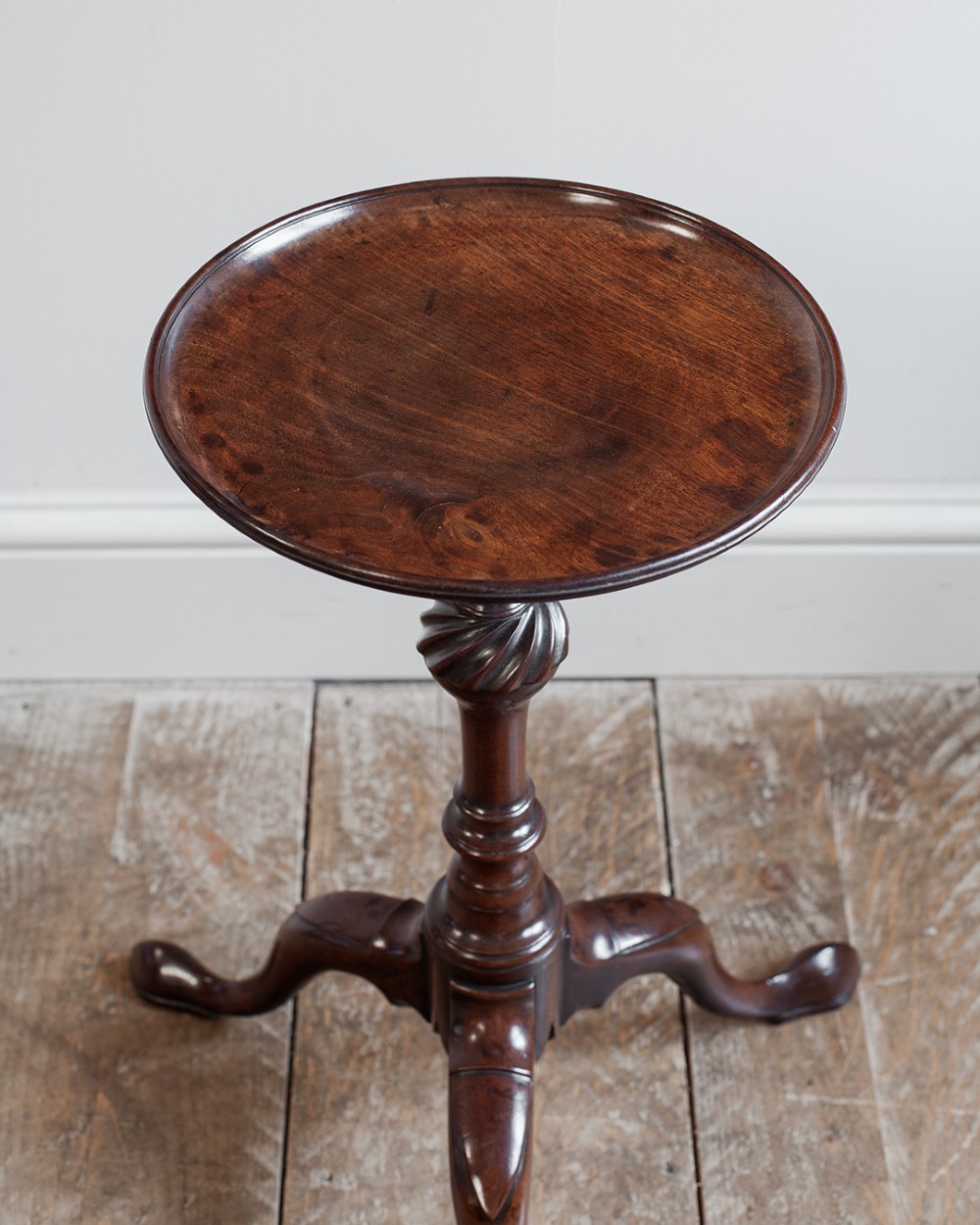 A Georgian dark mahogany kettle stand with a dished circular top, a turned stem with spiral fluting, and three cabriole legs. View VIII