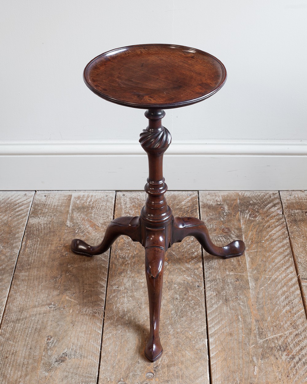 A Georgian dark mahogany kettle stand with a dished circular top, a turned stem with spiral fluting, and three cabriole legs. View IX