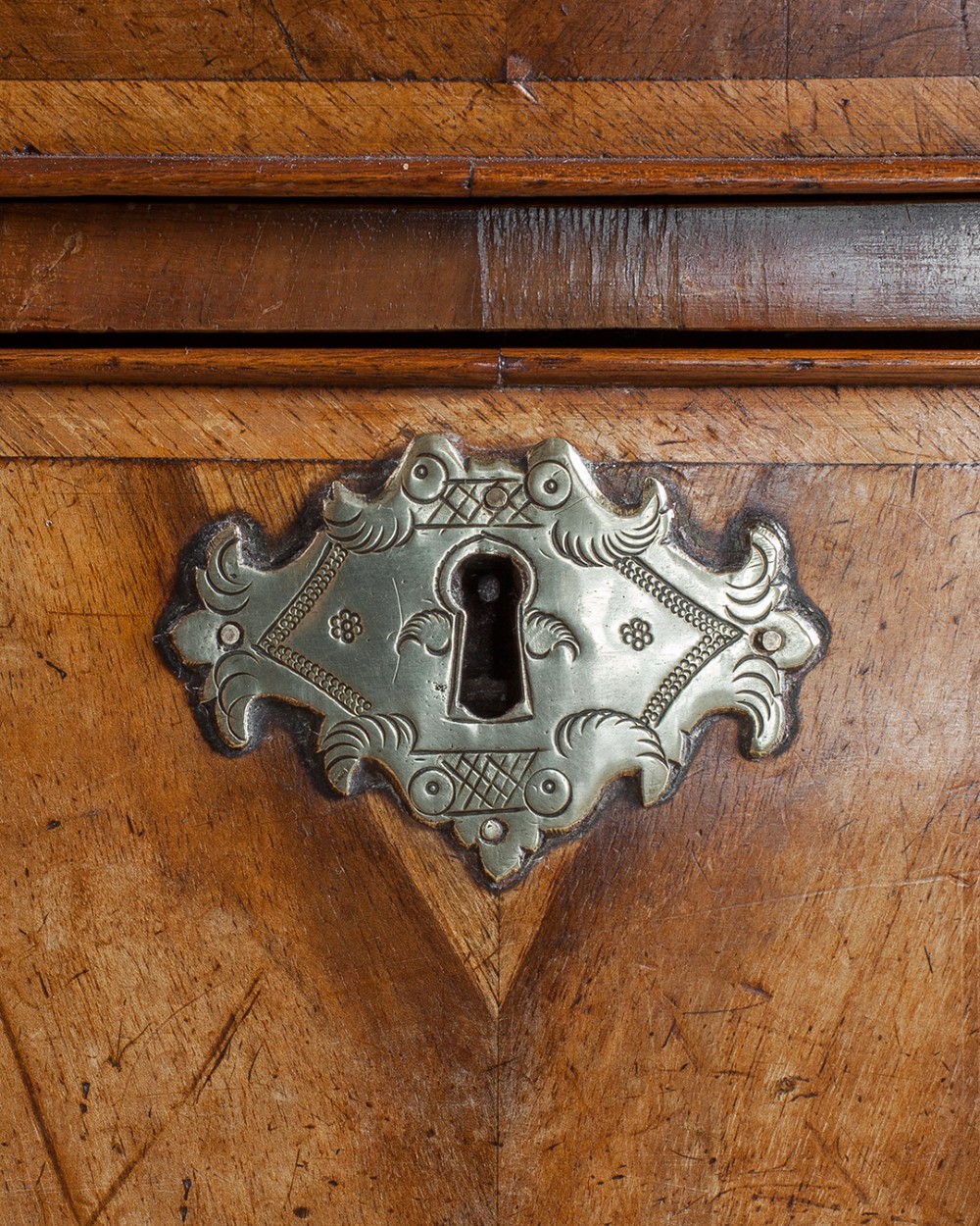 A two-part Georgian walnut chest on stand featuring multiple drawers with brass handles and escutcheons, supported by cabriole legs. View VIII