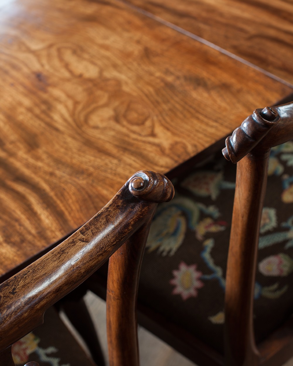 A set of twelve 18th-century carved walnut dining chairs featuring vase-shaped splats, cabriole legs, and floral needlepoint seats. View II