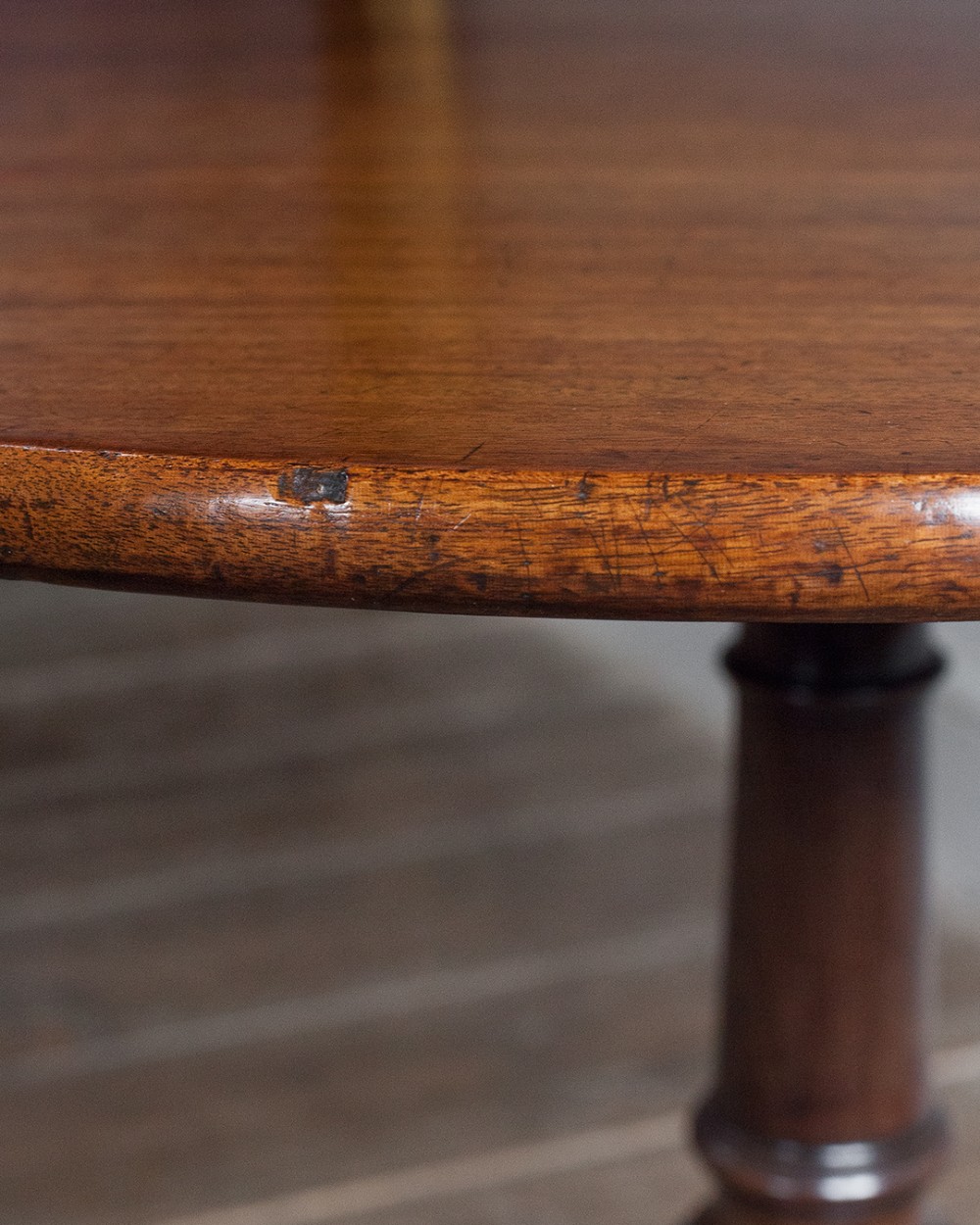 A George III mahogany tripod table featuring a circular top supported by a turned pedestal column with spiral carving and three cabriole legs. View II