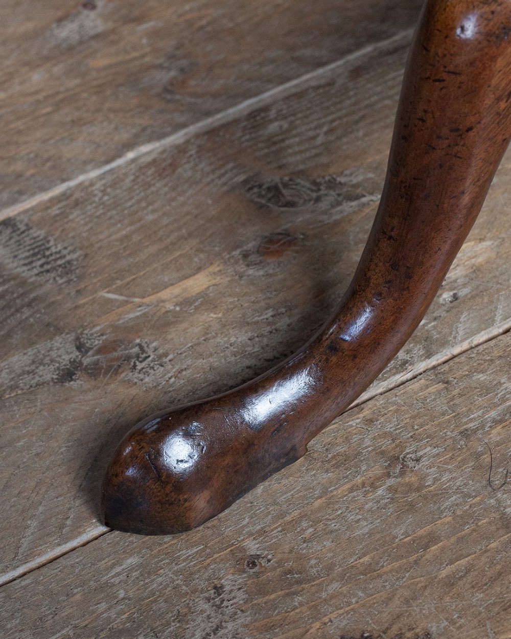A George III mahogany tripod table featuring a circular top supported by a turned pedestal column with spiral carving and three cabriole legs. View III