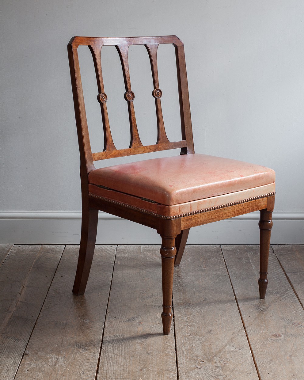 A 19th-century mahogany metamorphic chair shown unfolded into a set of four wooden library steps. View II