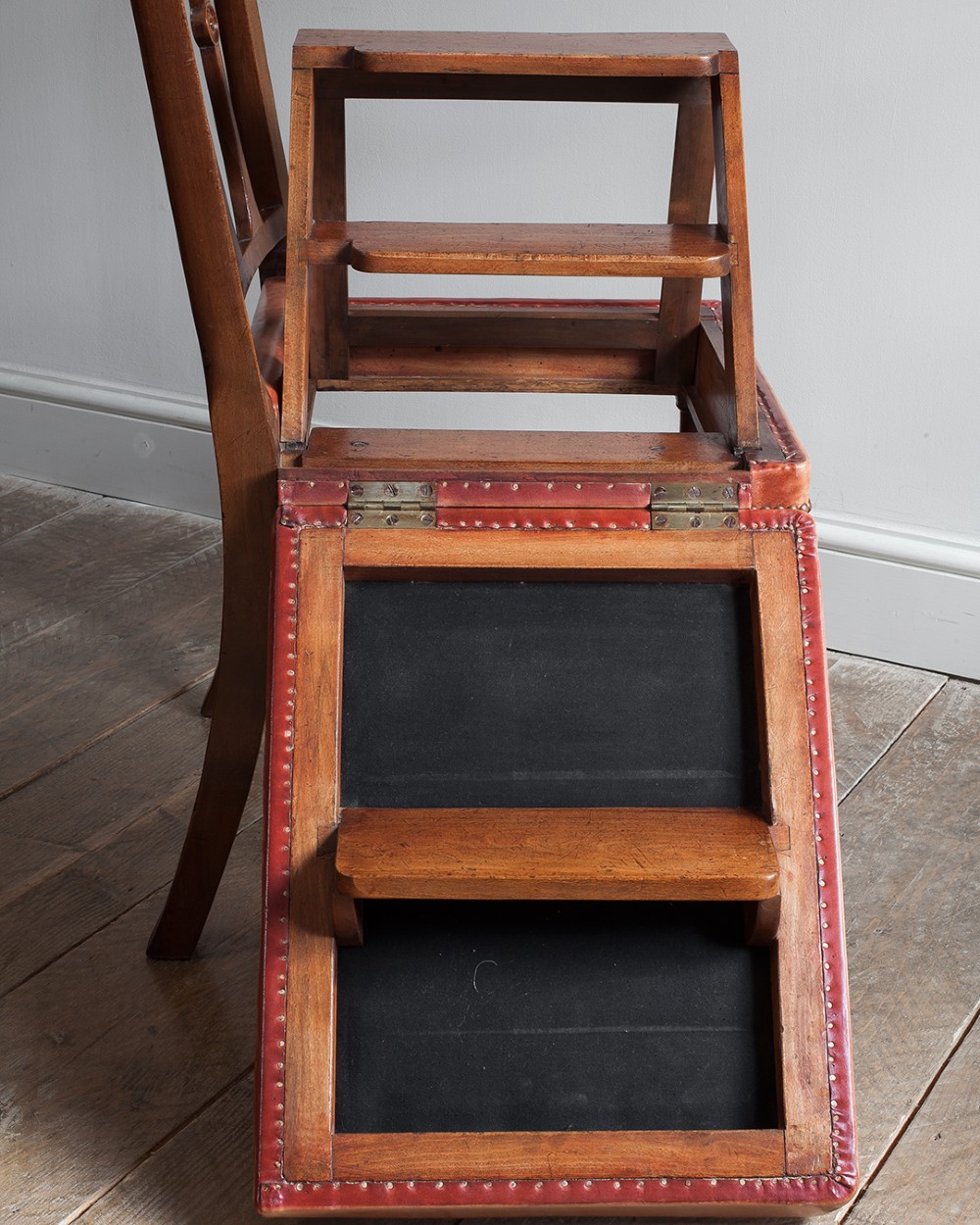 A 19th-century mahogany metamorphic chair shown unfolded into a set of four wooden library steps. View VI