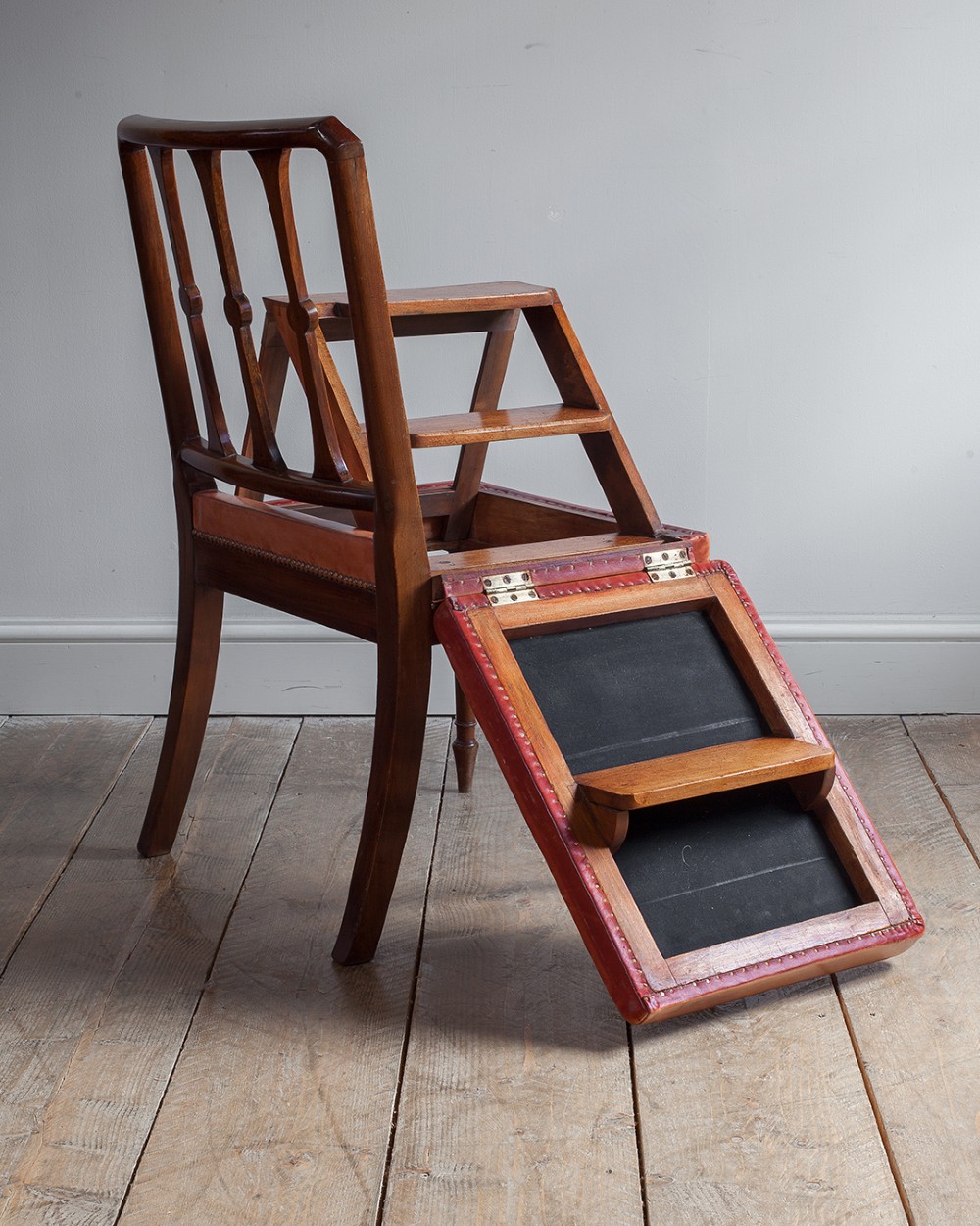 A 19th-century mahogany metamorphic chair shown unfolded into a set of four wooden library steps. View VII