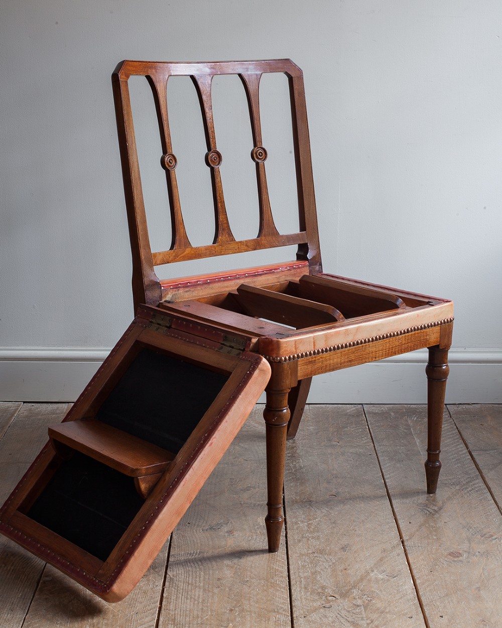 A 19th-century mahogany metamorphic chair shown unfolded into a set of four wooden library steps. View IX