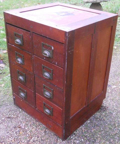 fig 1. An Edwardian mahogany filing cabinet featuring eight drawers arranged in two vertical rows with brass cup handles and card label plates.