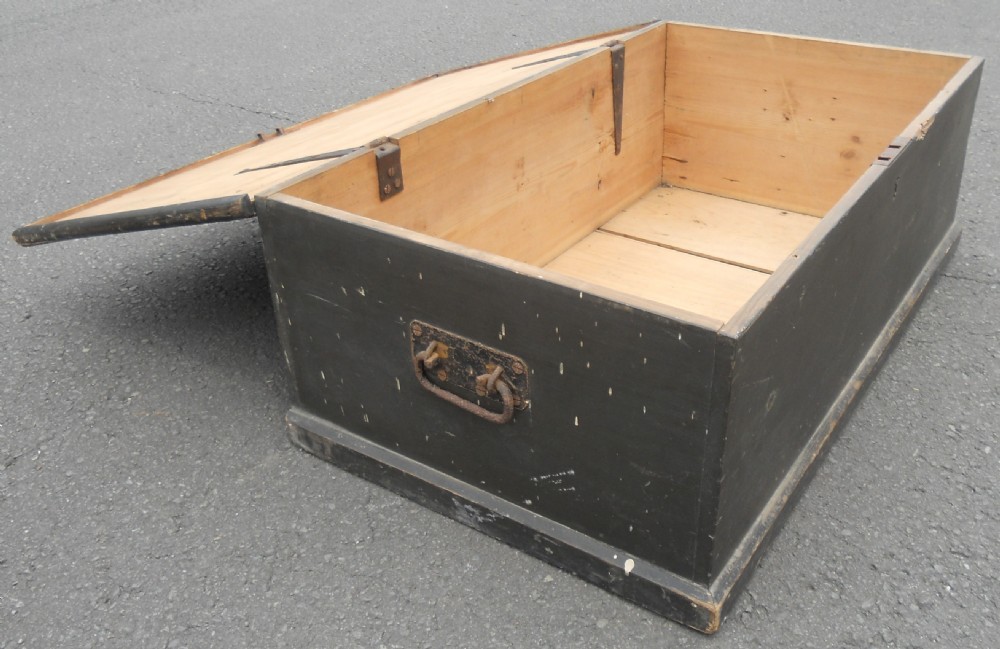 A rectangular black painted Victorian pine travelling box with a keyhole on the front panel and a metal plaque on the lid. View X