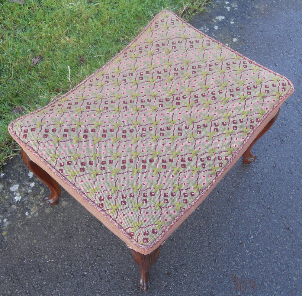 A Victorian walnut dressing stool featuring a concave seat with geometric tapestry fabric supported by four carved cabriole legs. View III