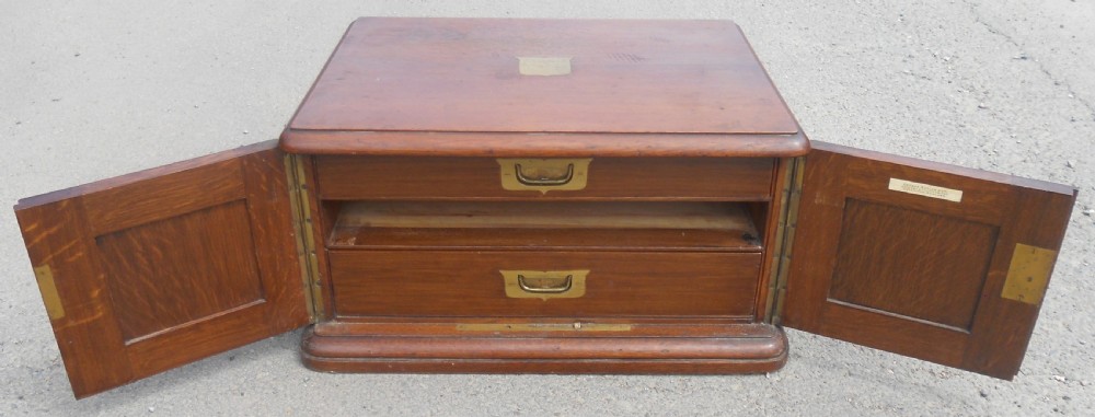 A large Victorian mahogany cutlery box featuring twin front panel doors, brass side handles, and a top brass plaque. View X