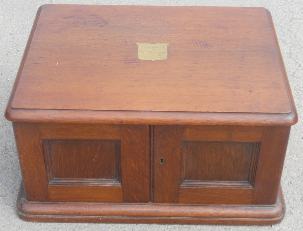A large Victorian mahogany cutlery box featuring twin front panel doors, brass side handles, and a top brass plaque. View XIII