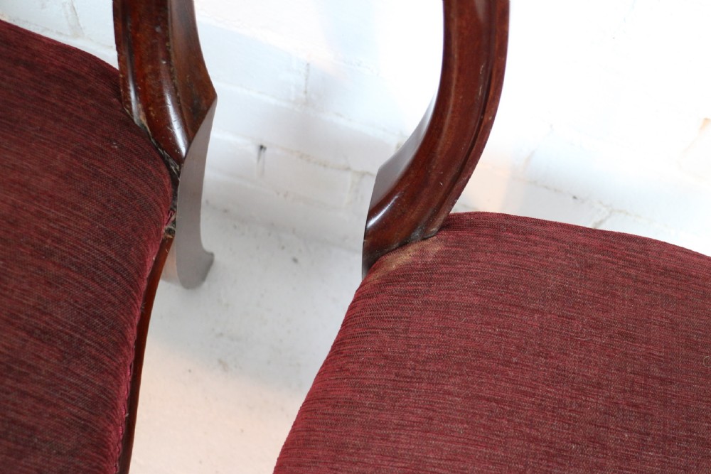 A set of ten William IV mahogany dining chairs with carved top rails, turned front legs, and deep red upholstery. View XXVIII