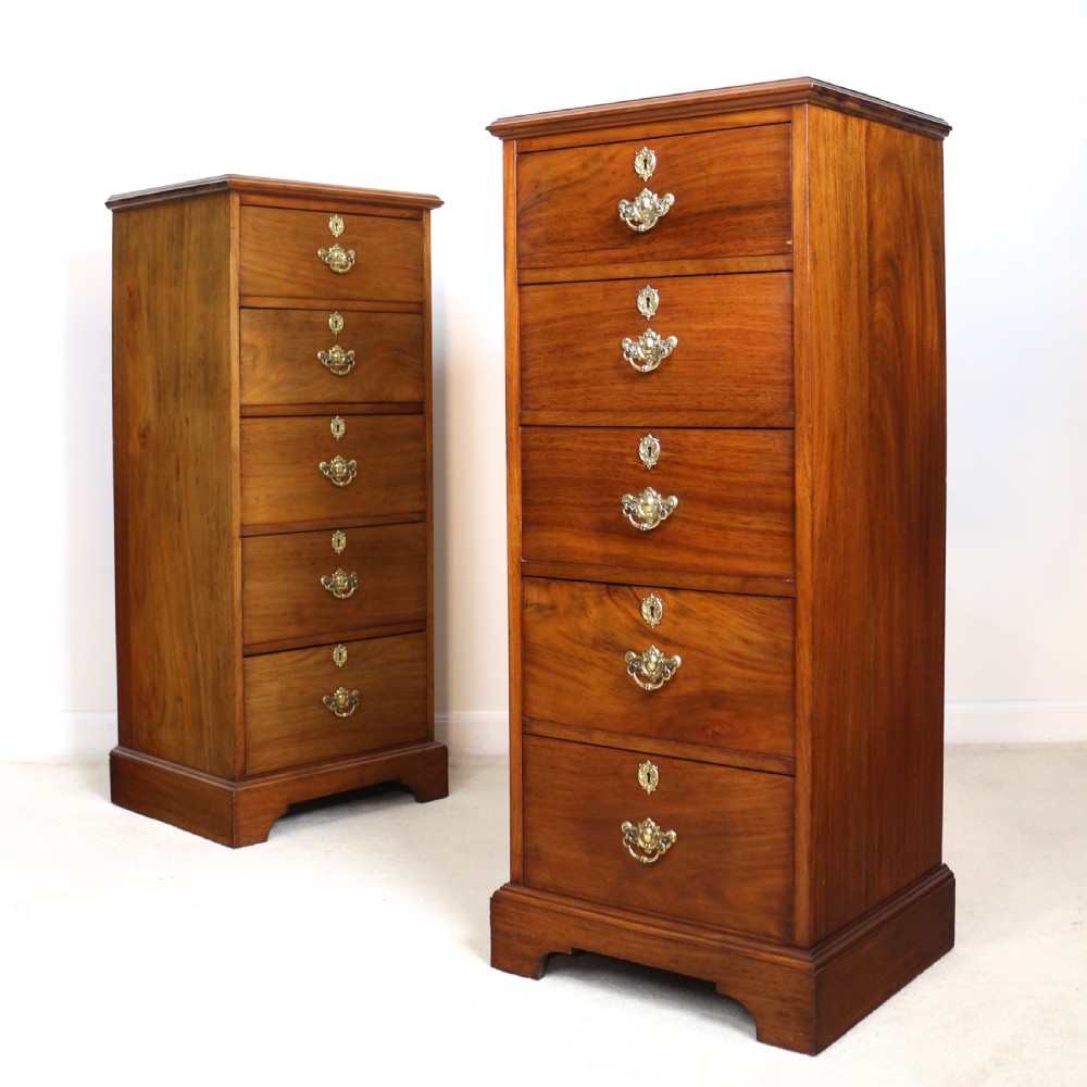 A pair of tall Scottish Late Victorian mahogany collectors chests with five drawers each, featuring brass drop handles and escutcheons.