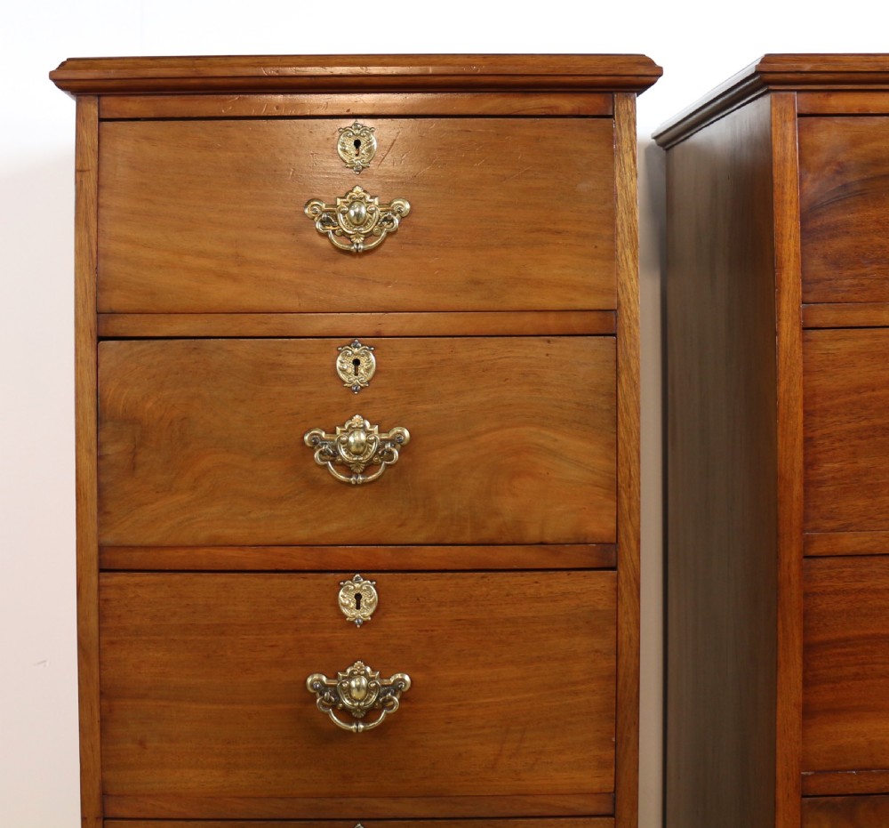A pair of tall Scottish Late Victorian mahogany collectors chests with five drawers each, featuring brass drop handles and escutcheons. View V