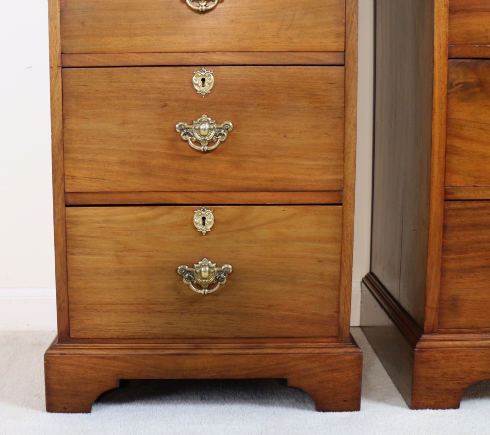 A pair of tall Scottish Late Victorian mahogany collectors chests with five drawers each, featuring brass drop handles and escutcheons. View VI