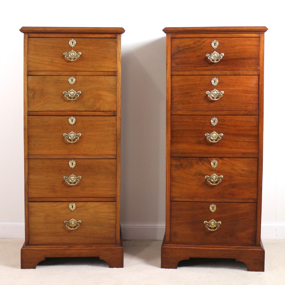 A pair of tall Scottish Late Victorian mahogany collectors chests with five drawers each, featuring brass drop handles and escutcheons. View VII