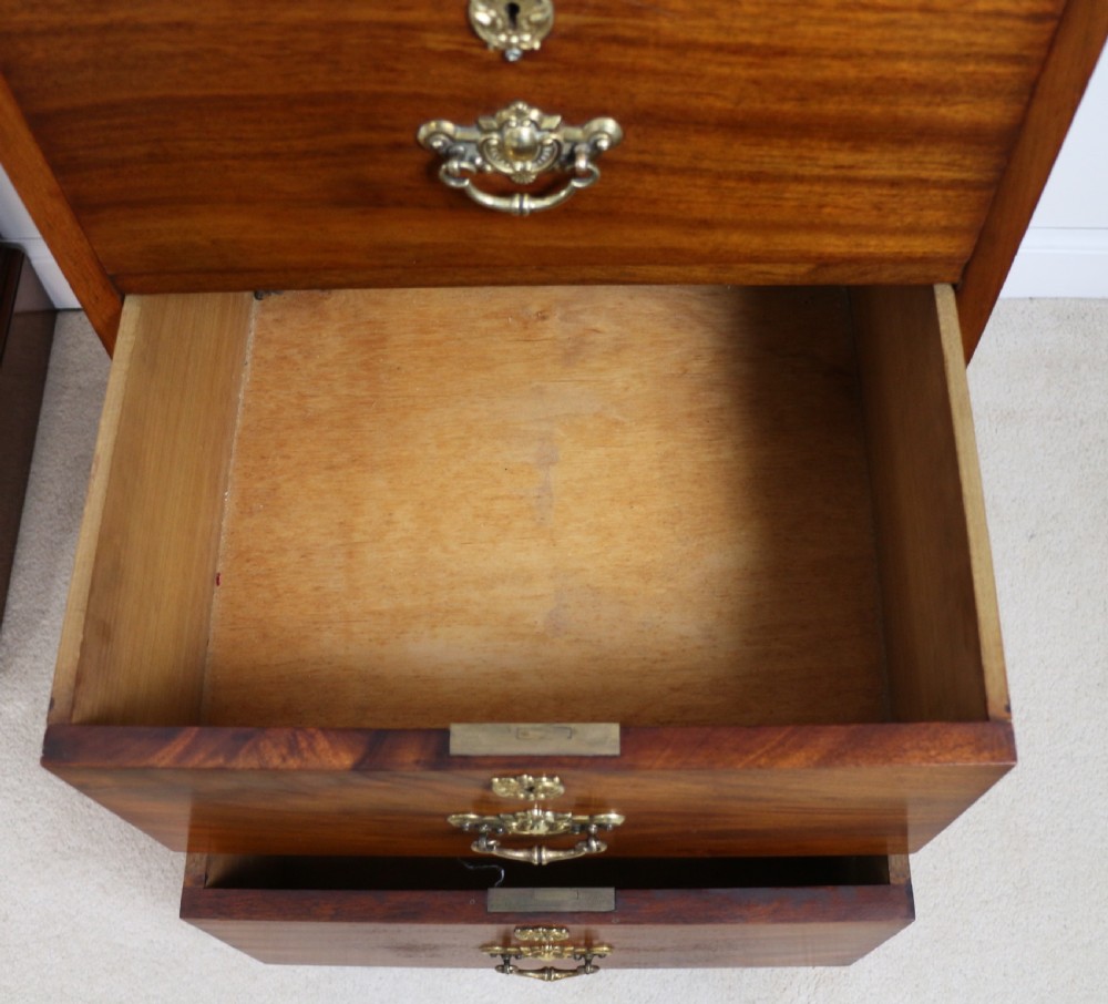A pair of tall Scottish Late Victorian mahogany collectors chests with five drawers each, featuring brass drop handles and escutcheons. View XXIV