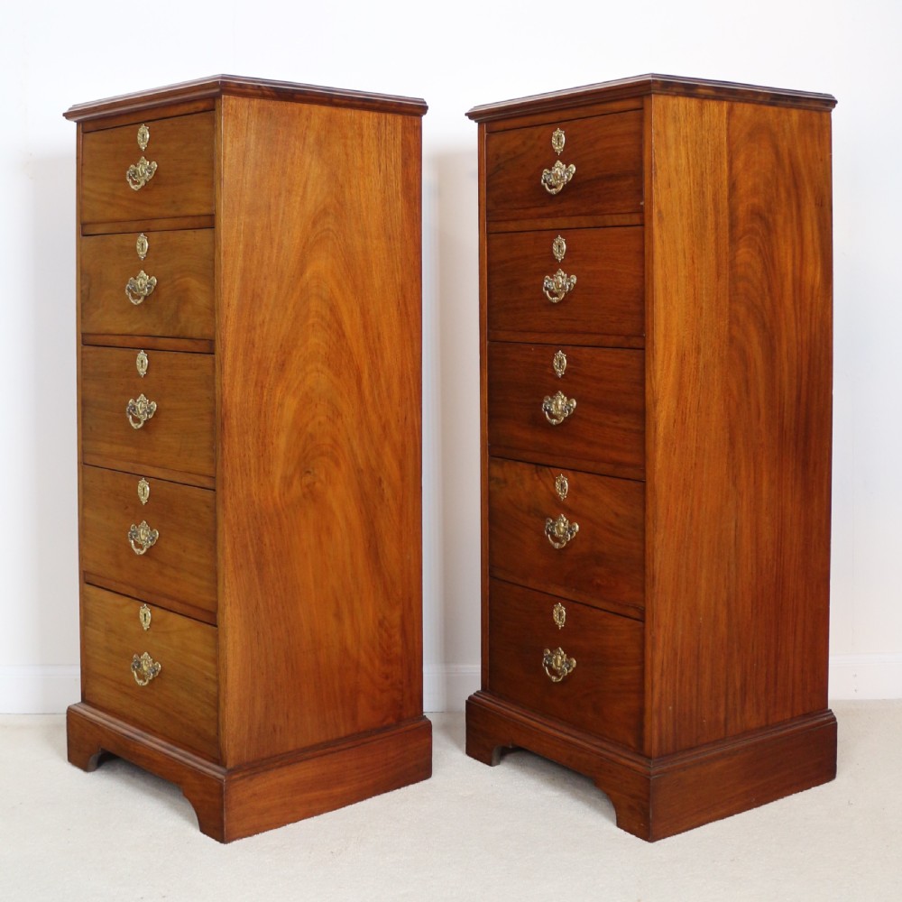A pair of tall Scottish Late Victorian mahogany collectors chests with five drawers each, featuring brass drop handles and escutcheons. View XXVIII