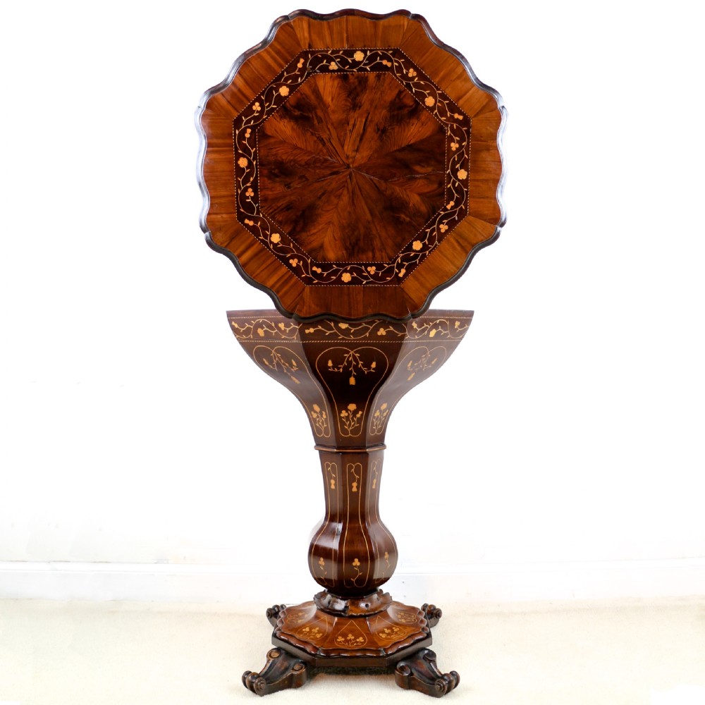 A Victorian Killarney Ware arbutus wood work table with a hinged scalloped top featuring shamrock marquetry on a faceted trumpet pedestal.