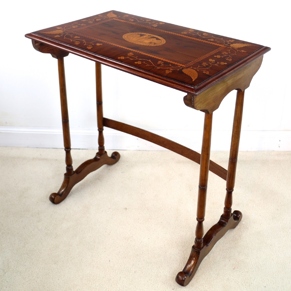 A set of three nested wooden side tables featuring detailed marquetry inlays of foliage and central vignettes, supported by slender turned legs and scroll feet. View XVII