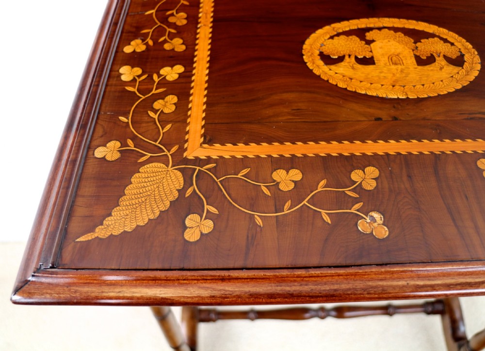 A set of three nested wooden side tables featuring detailed marquetry inlays of foliage and central vignettes, supported by slender turned legs and scroll feet. View XIX