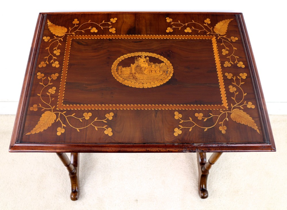 A set of three nested wooden side tables featuring detailed marquetry inlays of foliage and central vignettes, supported by slender turned legs and scroll feet. View XXII