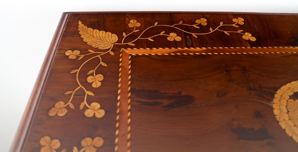 A set of three nested wooden side tables featuring detailed marquetry inlays of foliage and central vignettes, supported by slender turned legs and scroll feet. View XXIII