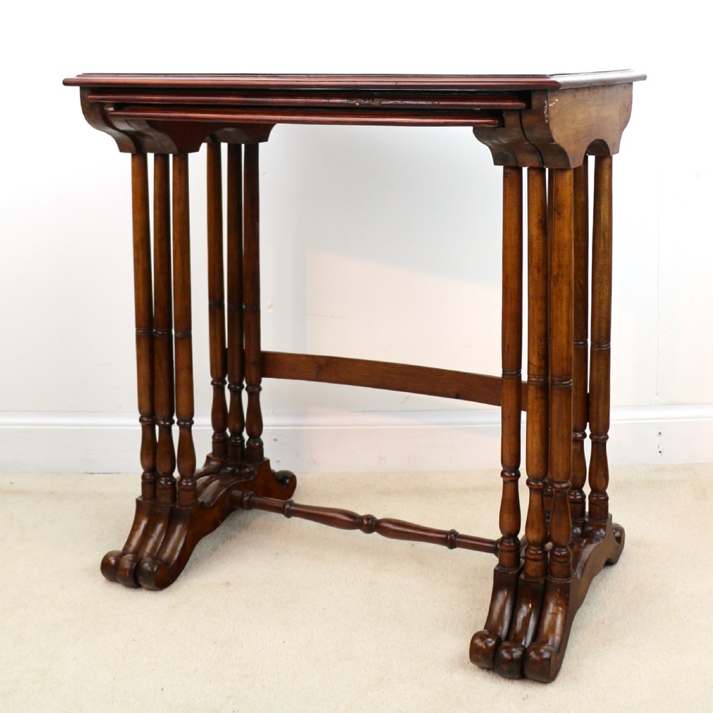 A set of three nested wooden side tables featuring detailed marquetry inlays of foliage and central vignettes, supported by slender turned legs and scroll feet. View XXIV