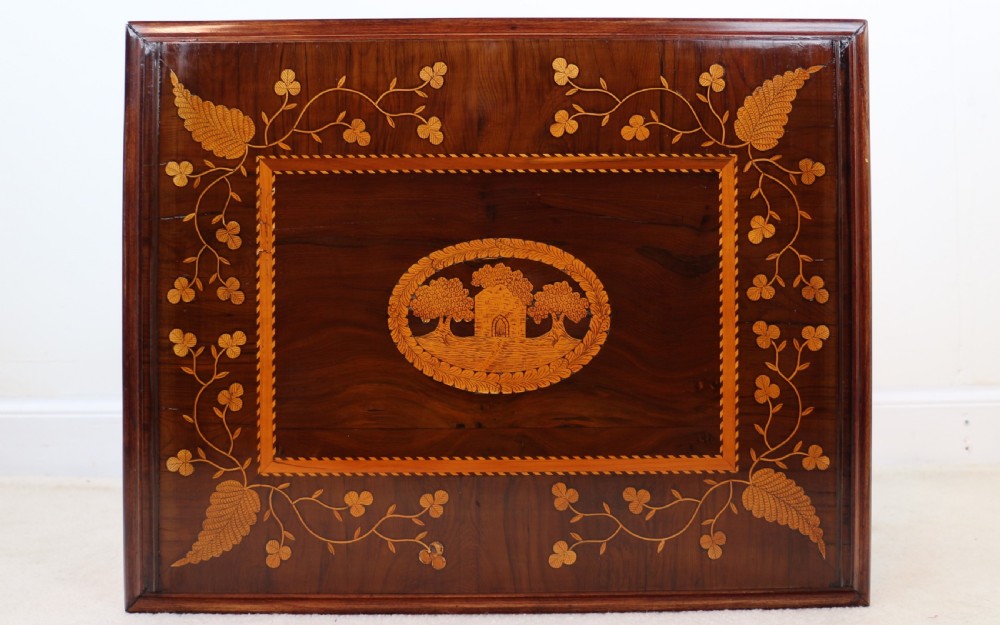 A set of three nested wooden side tables featuring detailed marquetry inlays of foliage and central vignettes, supported by slender turned legs and scroll feet. View XXIX