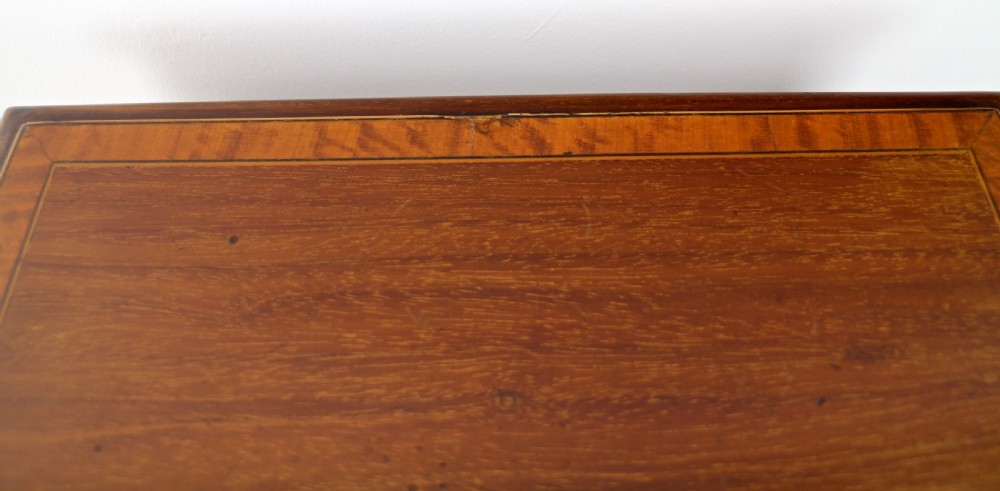 A tall Edwardian mahogany glazed bijouterie cabinet featuring glass panels on all sides, two interior shelves, square tapered legs, and satinwood crossbanding. View XXIII