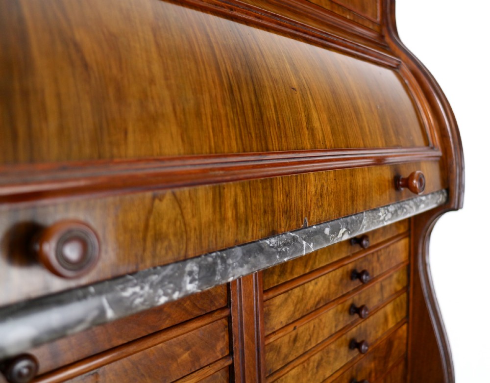A 19th-century Victorian burr walnut dentist cabinet with a roll-top upper section, shallow drawers, grey marble work surface, and lower two-door cupboard. View XV
