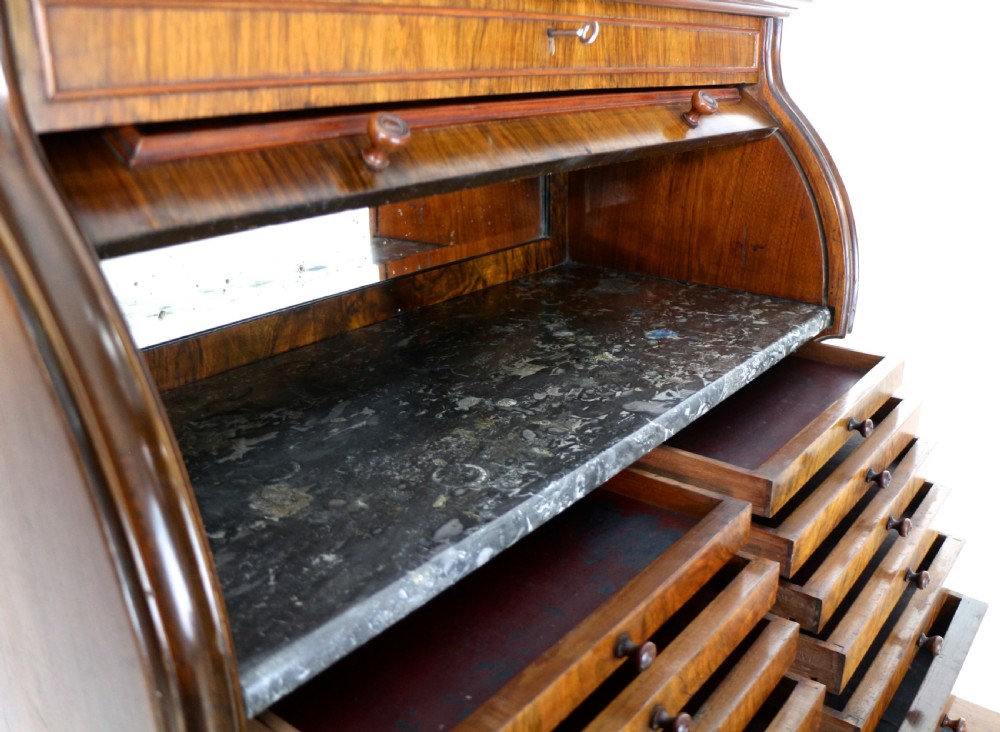 A 19th-century Victorian burr walnut dentist cabinet with a roll-top upper section, shallow drawers, grey marble work surface, and lower two-door cupboard. View XXV