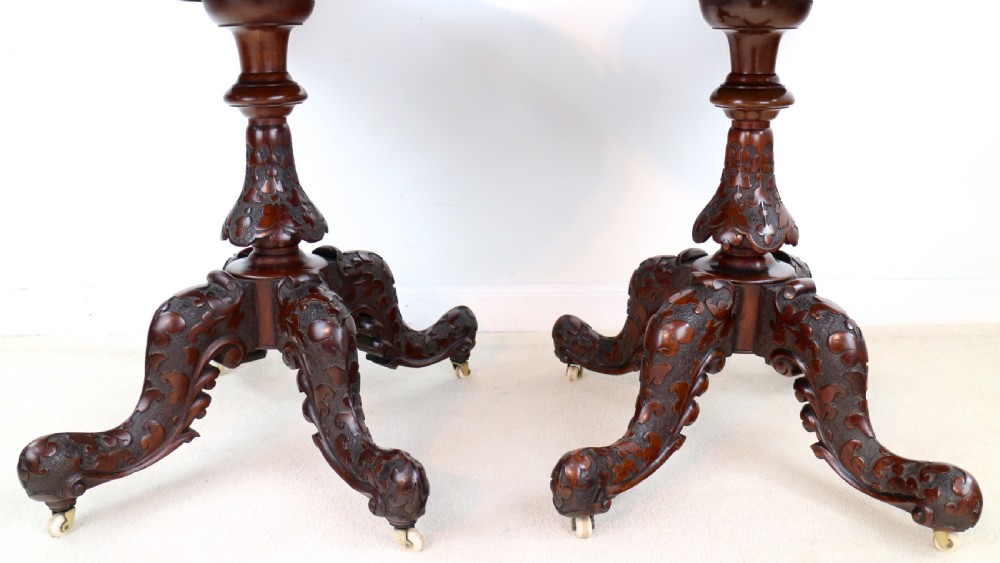 A pair of Victorian burr walnut fold-over card tables featuring shaped demi-lune tops, carved aprons, central turned pedestals, and carved quadform legs with castors. View XII
