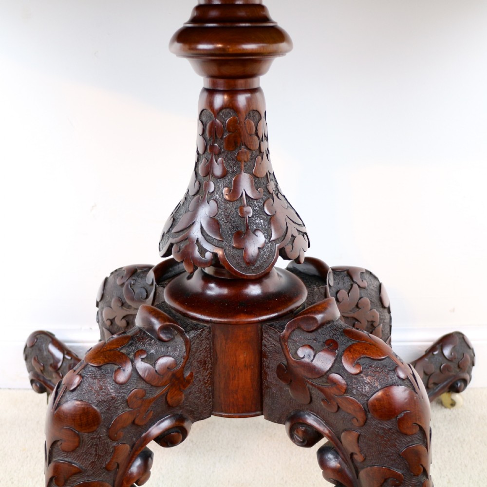 A pair of Victorian burr walnut fold-over card tables featuring shaped demi-lune tops, carved aprons, central turned pedestals, and carved quadform legs with castors. View XIII