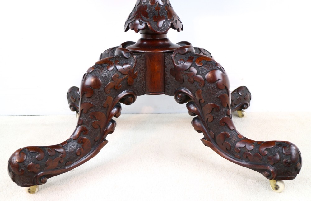 A pair of Victorian burr walnut fold-over card tables featuring shaped demi-lune tops, carved aprons, central turned pedestals, and carved quadform legs with castors. View XIV
