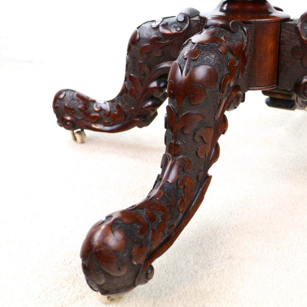 A pair of Victorian burr walnut fold-over card tables featuring shaped demi-lune tops, carved aprons, central turned pedestals, and carved quadform legs with castors. View XV