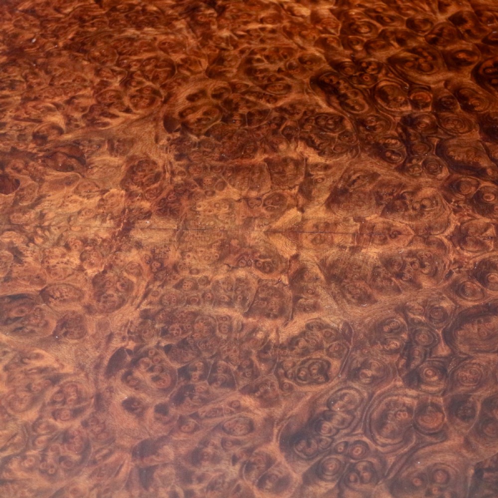 A pair of Victorian burr walnut fold-over card tables featuring shaped demi-lune tops, carved aprons, central turned pedestals, and carved quadform legs with castors. View XXIII