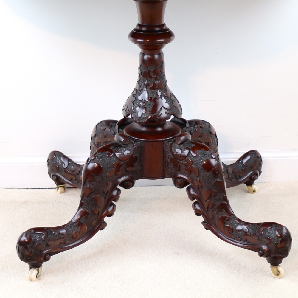 A pair of Victorian burr walnut fold-over card tables featuring shaped demi-lune tops, carved aprons, central turned pedestals, and carved quadform legs with castors. View XXV