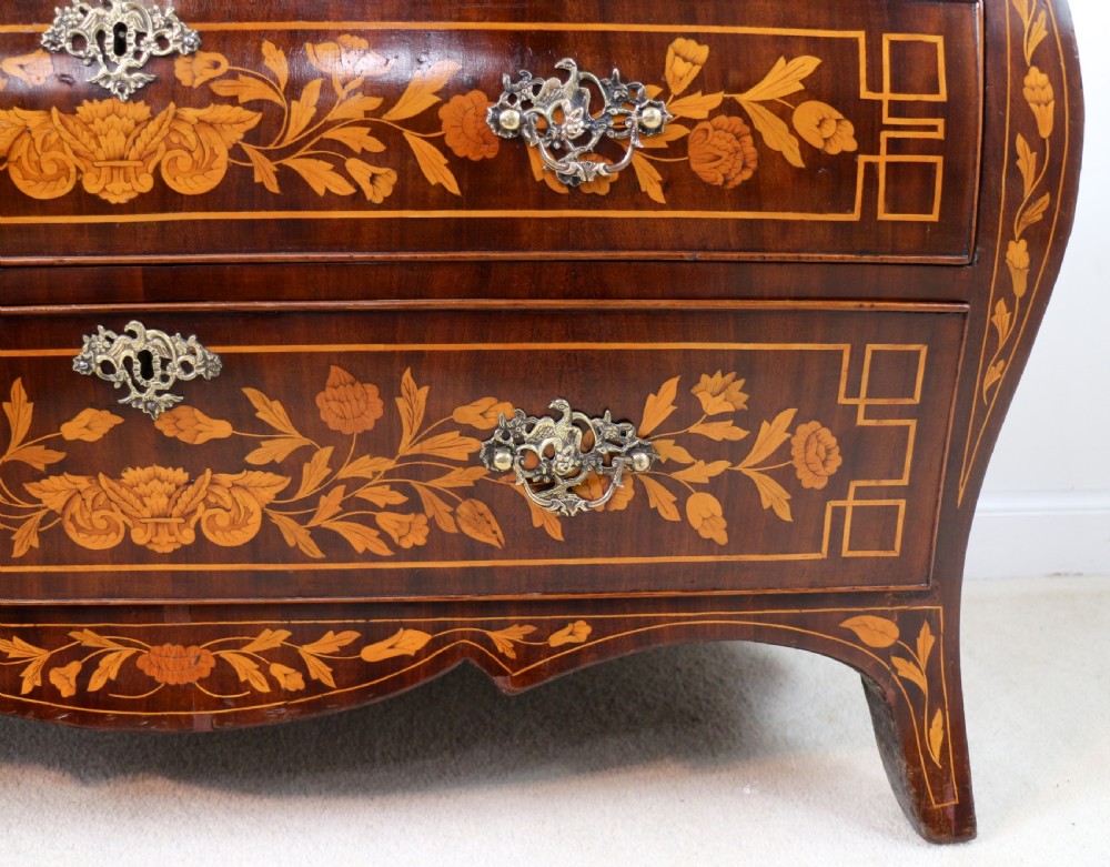 A 19th-century Dutch walnut bombe bureau decorated with intricate floral marquetry, featuring a slant front and curved drawers with brass handles. View XIV