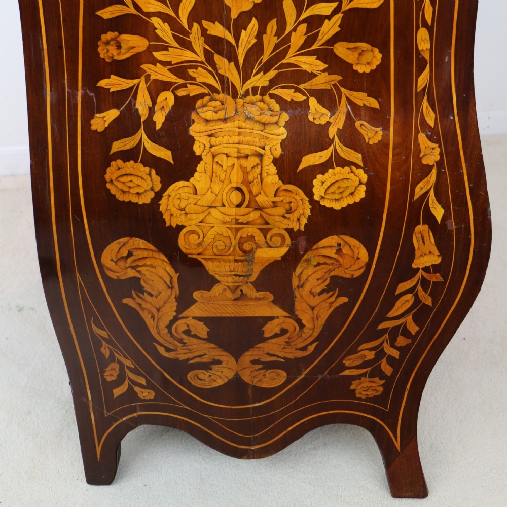 A 19th-century Dutch walnut bombe bureau decorated with intricate floral marquetry, featuring a slant front and curved drawers with brass handles. View XXIX