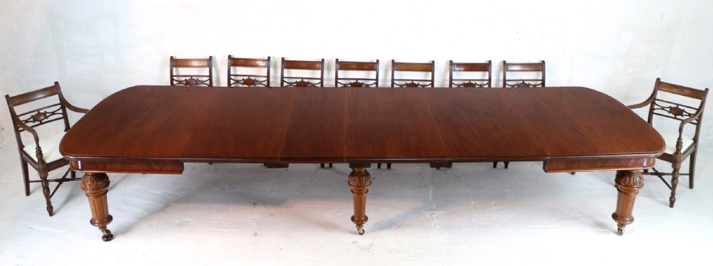 A large Victorian mahogany extending dining table featuring six turned carved legs fitted with brass castors and four removable leaf inserts. View II
