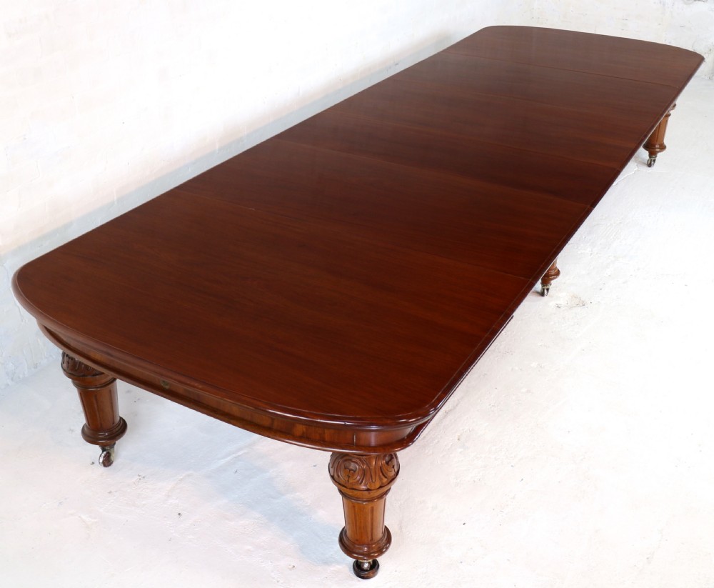 A large Victorian mahogany extending dining table featuring six turned carved legs fitted with brass castors and four removable leaf inserts. View XV