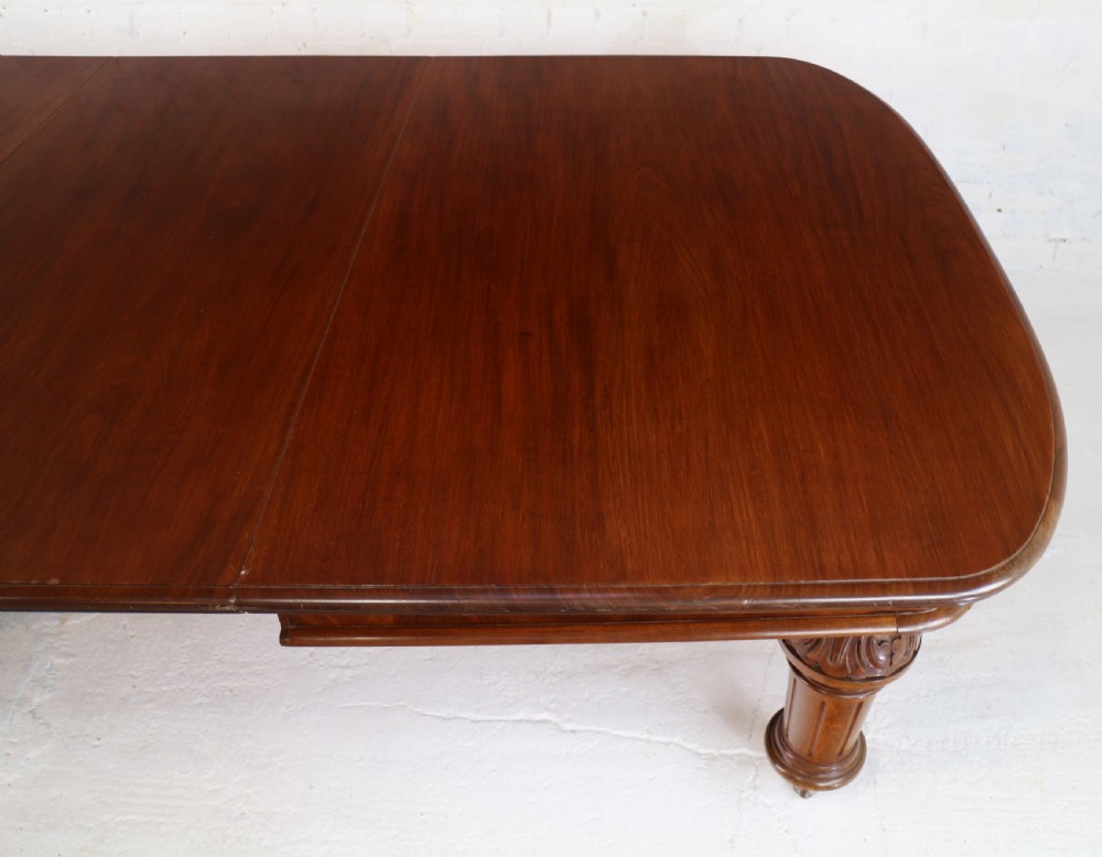 A large Victorian mahogany extending dining table featuring six turned carved legs fitted with brass castors and four removable leaf inserts. View XVIII